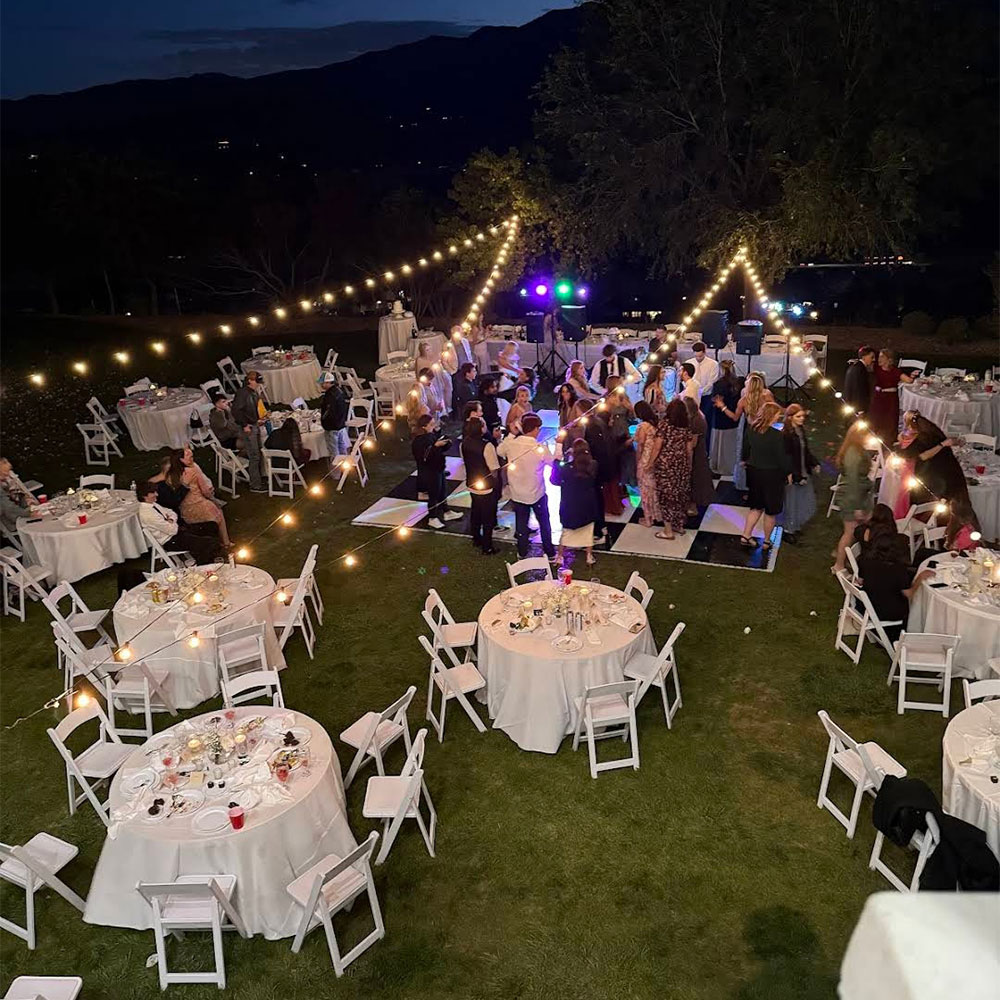 chairs and tables with string lights