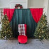 red santa chair with backdrop